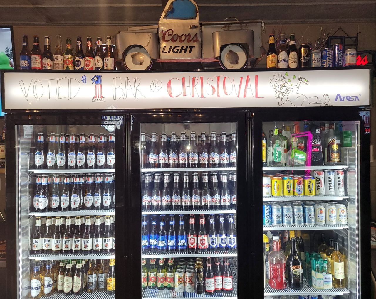 Three glass-door coolers stocked with bottled and canned beer